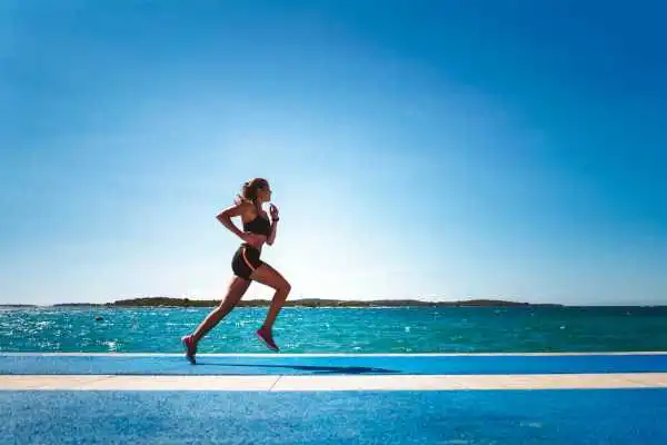 Woman running showing strong leg muscle Staines
